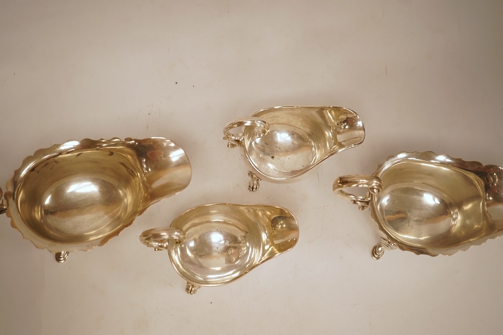 A pair of George V silver sauceboats, with cut borders and flying scroll handles, on three hoof feet, by J.B. Chatterley & Co Ltd, Birmingham, 1928, length 19.3cm, 19.3oz, together with a pair of silver plated Elkington
